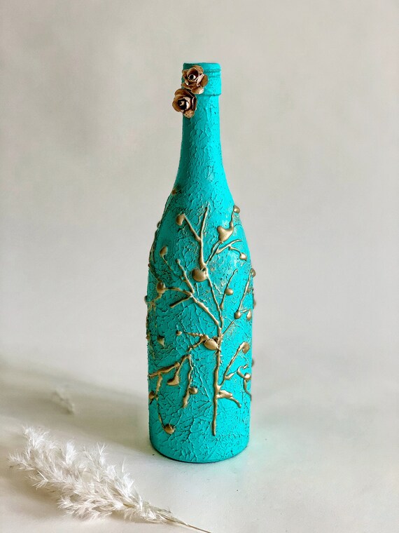 Decorated Wine Bottles.Decoupage Bottles.Altered Art.Mixed Media Art.Vintage Art Bottles.Decorative Bottles.Home Decor.Gift.Table Display Decorated wine bottles are a creative way to add a unique touch to your home decor or give as a thoughtful gift. Using techniques like decoupage, altering, and mixing various media, vintage art bottles can be transformed into beautiful pieces of art that can be displayed on a table or shelf to enhance the overall aesthetic of a room.