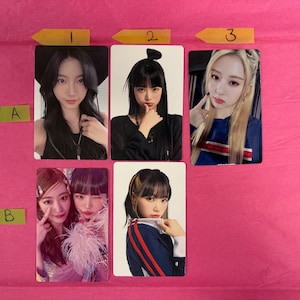 May include: A collection of six photo cards featuring images of various people. The cards are arranged in two rows of three, with each person posing for the camera. The background is a solid pink color.