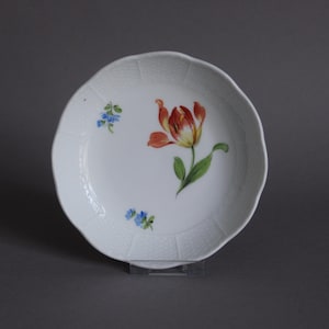 May include: A set of three ceramic mugs with a speckled, matte finish. Each mug features a different color: light blue, cream, and gray. The mugs have a simple, modern design and a comfortable handle.