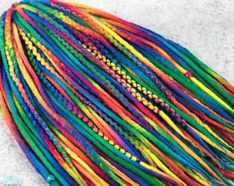 May include: A set of colorful wool dreadlocks with rainbow ombre dyeing. The dreadlocks are tied together with a yellow string and have beads at the ends.