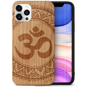 May include: A wooden phone case with a mandala design and the Om symbol engraved in the center. The case is made of natural wood and has a light brown color. The text "Case Yard" is engraved in the bottom right corner.