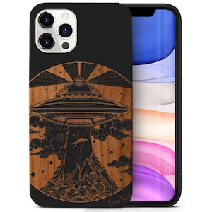 May include: A black phone case with a wood-grain design featuring a black and white illustration of a UFO hovering over a mountain range. The text "Case Yard" is visible at the bottom of the design.