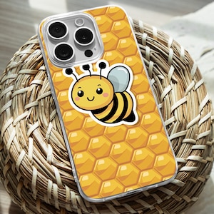 May include: A clear phone case with a honeycomb pattern and a cartoon bee design. The bee is yellow and black with a cute face.