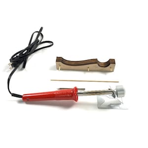 May include: A red soldering iron with a black power cable, a wooden stand, and a metal tip. The soldering iron has a silver tip and a red handle. A wooden stand with dowels is also included.
