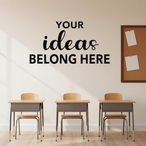 May include: A classroom scene with three student desks and chairs. The desks have a light wood top and a gray metal frame. The text "YOUR ideas BELONG HERE" is displayed on the wall above the desks. A corkboard with two white papers is on the right.