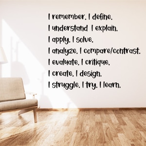May include: A motivational quote on a white wall in a room with a light brown armchair. The quote reads: "I remember. I define. I understand I explain. I apply. I solve. I analyze. I compare/contrast. I evaluate. I critique. I create. I design. I struggle. I try. I learn."