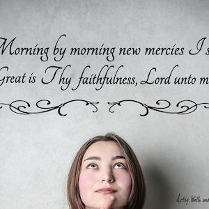 May include: A woman looks up at a wall with a quote from the Bible: "Morning by morning new mercies I see. Great is Thy faithfulness, Lord unto me."