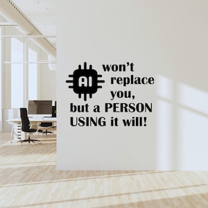 May include: Black and white wall decal with a computer chip graphic and the text "AI won't replace you, but a PERSON USING it will!"