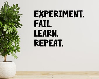 May include: Black and white text on a white wall that reads "EXPERIMENT. FAIL. LEARN. REPEAT."