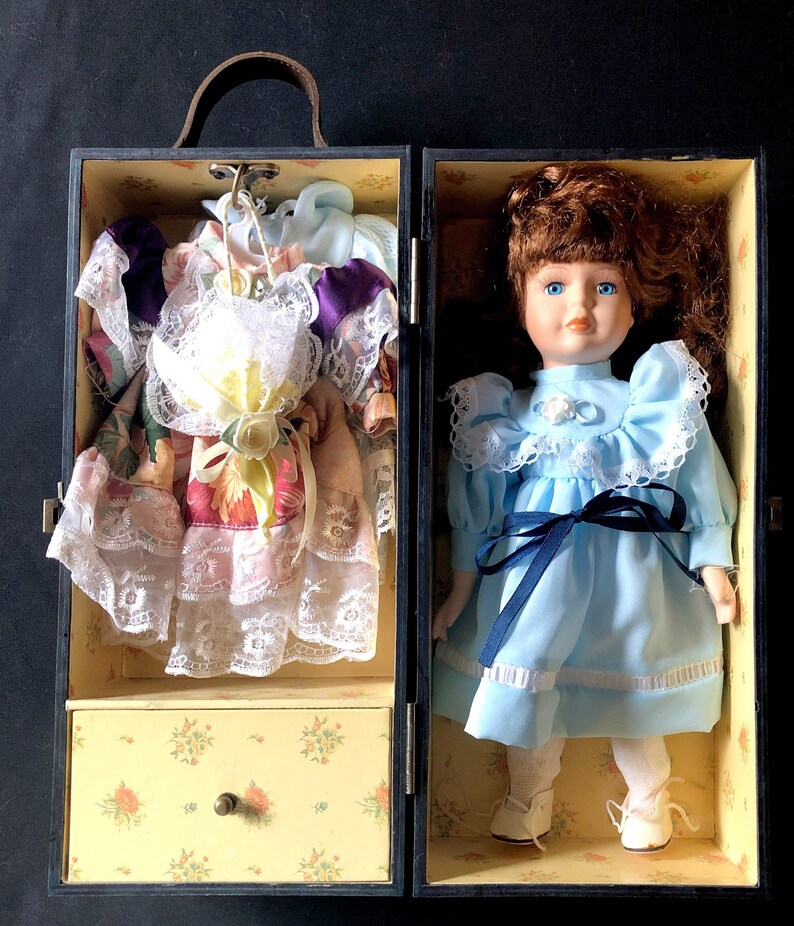 porcelain doll in wooden box