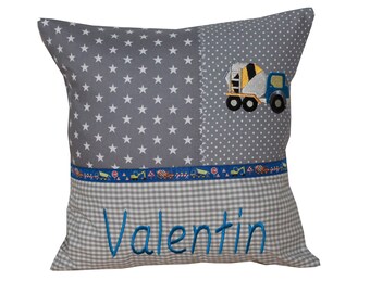 Cuddly pillow with construction vehicle and desired name