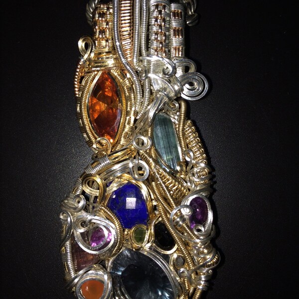 The C.O.S.M.O.S pendant, flurorite, topaz, opal, amythest, tourmaline, herkimer, spinel, garnet wire wrapped pendant