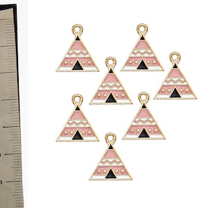 May include: Seven gold-colored metal charms shaped like pink and white teepees with black accents. The charms have a loop at the top for attaching to jewelry or other crafts.