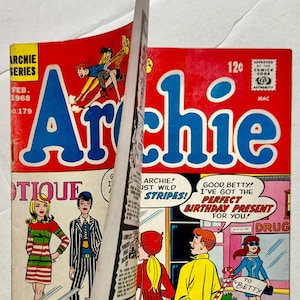May include: A vintage Archie comic book cover with a red background and the title "Archie" in large blue letters. The cover features comic book characters and text that reads "Archie! Just Wild Stripes!" and "Good Betty! I've got the perfect birthday present for you!"