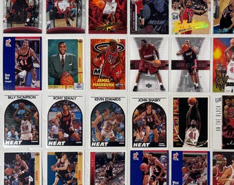 May include: A collection of basketball trading cards featuring Miami Heat players. The cards display action shots of players in their uniforms, with team logos and player names. The cards are in various colors, including red, black, and white.
