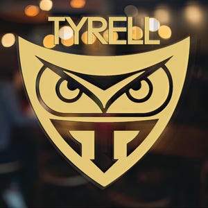 May include: A gold-colored logo with the word "TYRELL" above an owl with a black outline and a stylized "T" below. The logo is on a dark background.