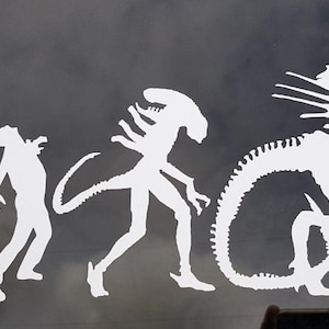 May include: White silhouette decal of the evolution of the Alien creature from the movie franchise. The decal shows the creature's progression from a small egg to a fully grown Xenomorph.