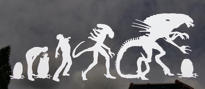 May include: White silhouette decal of the evolution of the Alien creature from the movie franchise. The decal shows the creature's progression from a small egg to a fully grown Xenomorph.