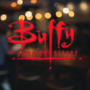 May include: Red and black logo on a glass window with the text "Buffy the Vampire Slayer".