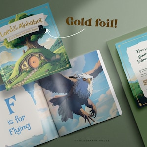 Pu&ograve; includere: Un libro per bambini intitolato Lord of the Alphabet: A to Z there and back again, raffigurante una collina verde con una porta rotonda e un grande albero. Le pagine aperte mostrano un'aquila in volo con il testo F is for Flying e dettagli in oro.