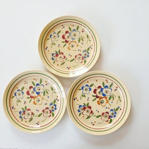 3 vintage vanilla yellow ceramic plates. Antiques from Belgium / France. Red, blue, yellow flowers, Spritzdekor airbrush. Folk style pottery