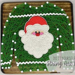 May include: Green string art kit of a Christmas sweater with a Santa Claus face on it. The kit includes a wooden base, string, and nails. "Do It Yourself String Art Kit" is written below the image.