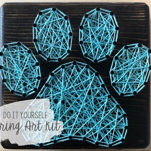 May include: DIY string art kit featuring a turquoise paw print design on a dark wood background. The text "DO IT YOURSELF string Art kit" is printed below the paw print.