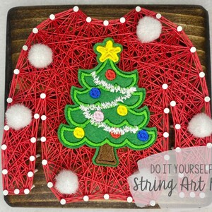May include: DIY string art kit featuring a red sweater with a green Christmas tree design. The kit includes all the materials needed to create the artwork, including string, nails, and a wooden base.  Do It Yourself String Art Kit.