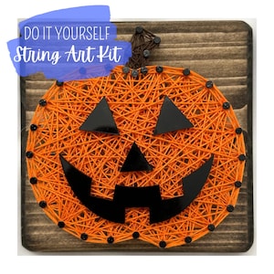 May include: A DIY string art kit featuring an orange pumpkin design. The pumpkin is made of orange string on a wooden board, with black triangle eyes and a mouth. The text "DO IT YOURSELF String Art Kit" is in a blue banner.