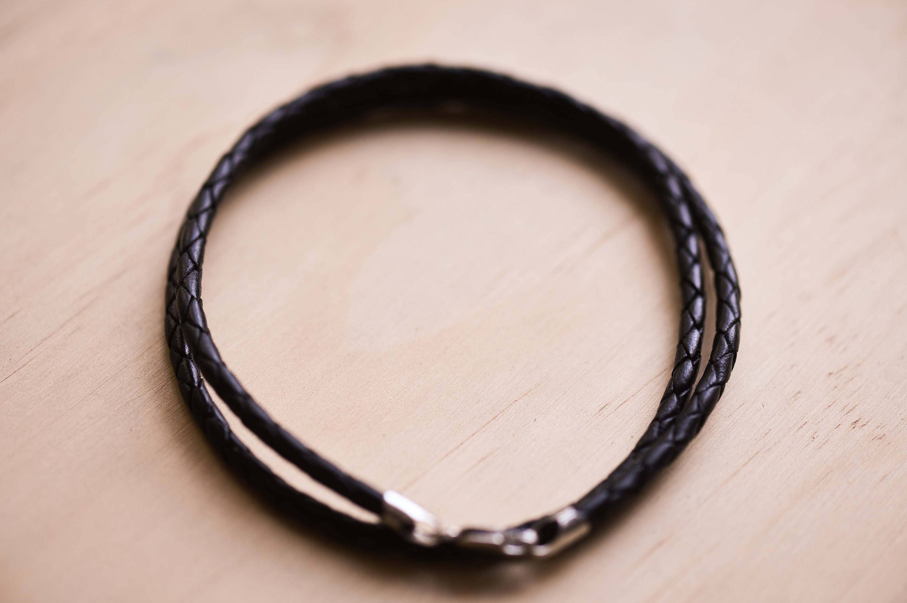 Etimoe Wood Geometric Pendant With a Braided Black Leather Etimoe Wood Geometric Pendant With a Braided Black Leather