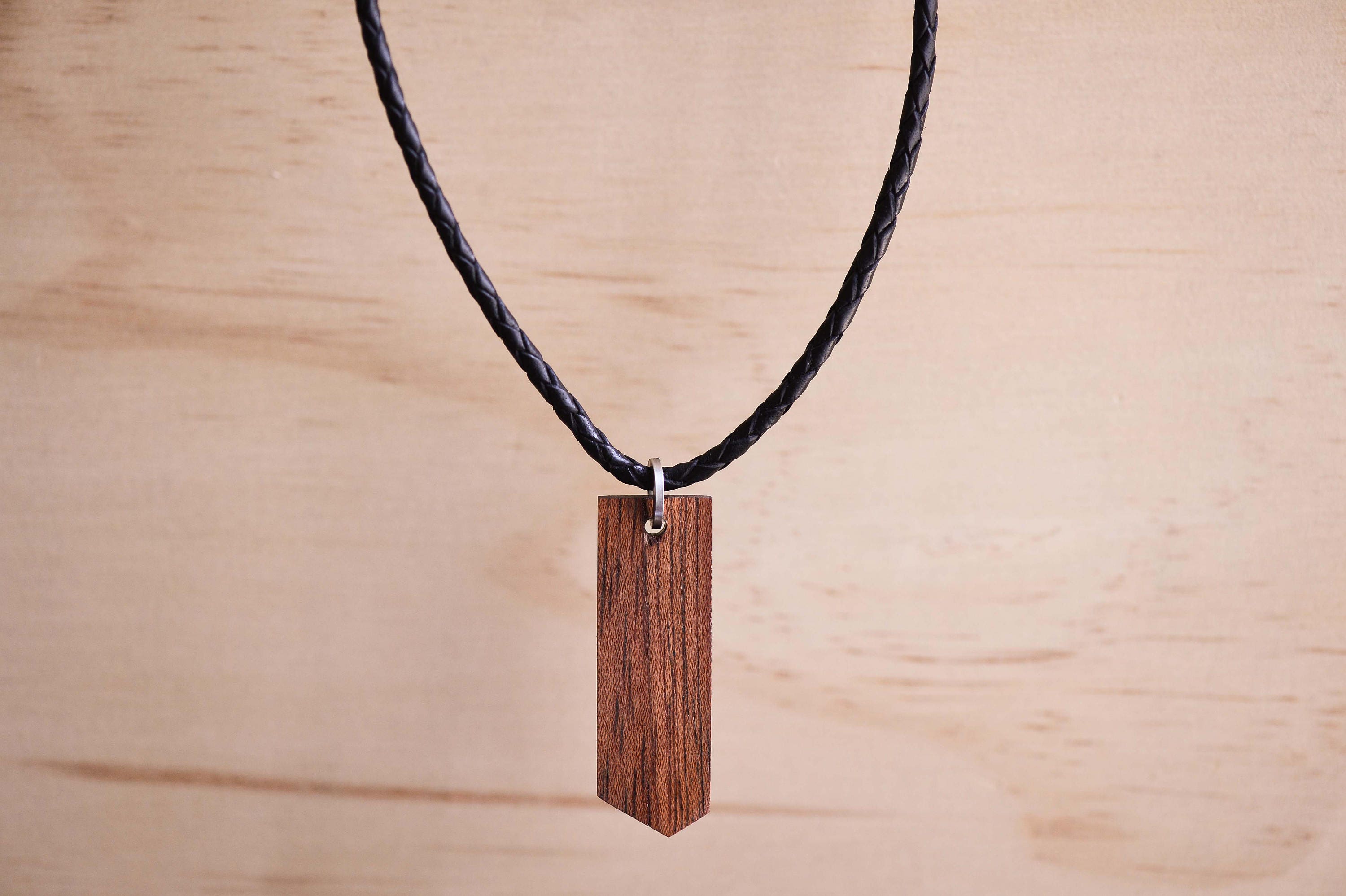 Etimoe Wood Geometric Pendant With a Braided Black Leather Etimoe Wood Geometric Pendant With a Braided Black Leather