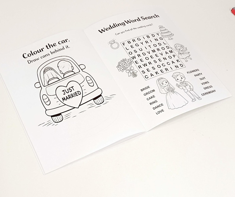 May include: An open activity book with black and white line art. The left page features a car with a Just Married heart sign and text Colour the car. Draw cans behind it. The right page shows a Wedding Word Search with illustrations of a couple.
