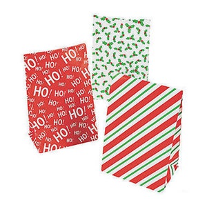 May include: Three Christmas gift bags with different designs. One bag is red with white "HO!" text, another is white with green holly leaves and red berries, and the last is red and green striped.