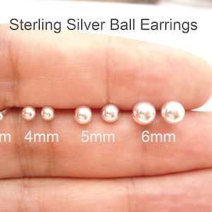 May include: Sterling Silver Ball Earrings. The image displays four pairs of spherical stud earrings in graduated sizes labeled 3mm, 4mm, 5mm, and 6mm. Each pair features a polished, reflective metallic finish on the round ball studs.
