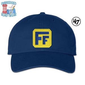 May include: A navy blue baseball cap with a yellow and blue embroidered patch that says "FF" on the front. The cap has a curved brim and a 47 brand logo on the side.