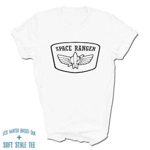 May include: White t-shirt with a black graphic of a space ranger patch. The patch has a rocket ship with wings and the text "SPACE RANGER".