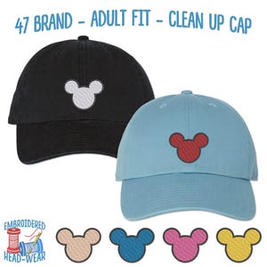 May include: Two baseball caps with embroidered Mickey Mouse ears. One cap is black with white ears, the other is light blue with red ears. The caps are labeled "47 Brand - Adult Fit - Clean Up Cap".