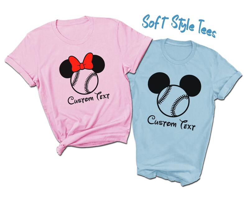 May include: Two soft style t-shirts, one pink and one light blue, with a baseball and Mickey Mouse ears design. The pink shirt has a red bow on the Mickey Mouse ears. Both shirts say "Custom Text" underneath the design.