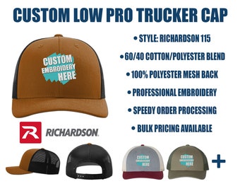 May include: A brown and black trucker cap with a custom embroidery option. The cap is made of a 60/40 cotton/polyester blend with a 100% polyester mesh back. The text "CUSTOM EMBROIDERY HERE" is displayed on the cap.