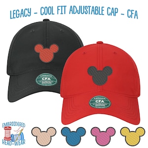 May include: Two adjustable baseball caps with embroidered Mickey Mouse ears. One cap is black with red Mickey Mouse ears and the other is red with black Mickey Mouse ears. Both caps have a green label with the text "LEGACY CFA" on them.