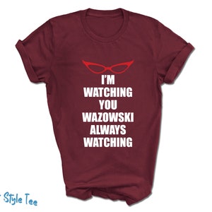 May include: Burgundy t-shirt with white text that reads "I'm watching you Wazowski always watching" and a red pair of glasses graphic.