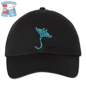 May include: Black baseball cap with an embroidered blue manta ray design. The cap has a curved brim and an adjustable strap.