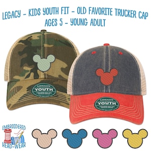 May include: Two trucker caps with a Mickey Mouse silhouette embroidered on the front. One cap is camouflage with a light green Mickey Mouse, and the other is dark blue with a red Mickey Mouse. Both caps have a mesh back and a label that says "Legacy Youth".