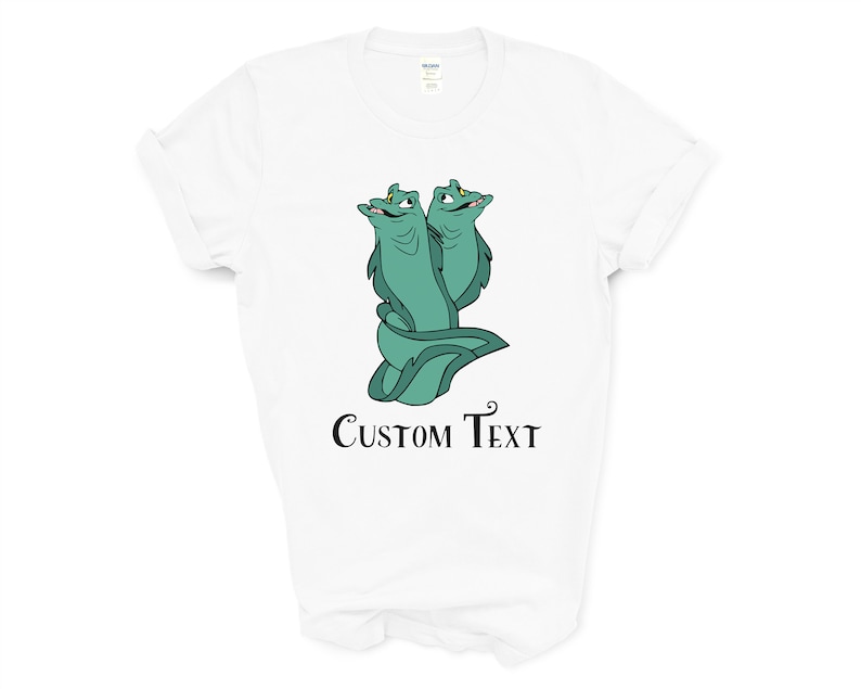 May include: White t-shirt with a green cartoon image of two eels with yellow eyes and the text "CUSTOM TEXT" printed below the image.