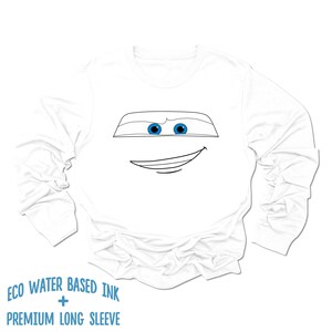 May include: White long-sleeve shirt with a black and white line drawing of a cartoon character with blue eyes. The text "ECO WATER BASED INK + PREMIUM LONG SLEEVE" is printed on the bottom of the shirt.