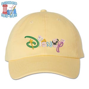May include: A yellow baseball cap with an embroidered multi-colored Disney logo.
