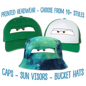 May include: Three different styles of hats with a cartoon eye design printed on them. The hats are a green baseball cap, a white and green trucker hat, and a blue and green bucket hat. The text "PRINTED HEADWEAR - CHOOSE FROM 10+ STYLES" is at the top of the image. The text "CAPS - SUN VISORS - BUCKET HATS" is at the bottom of the image.