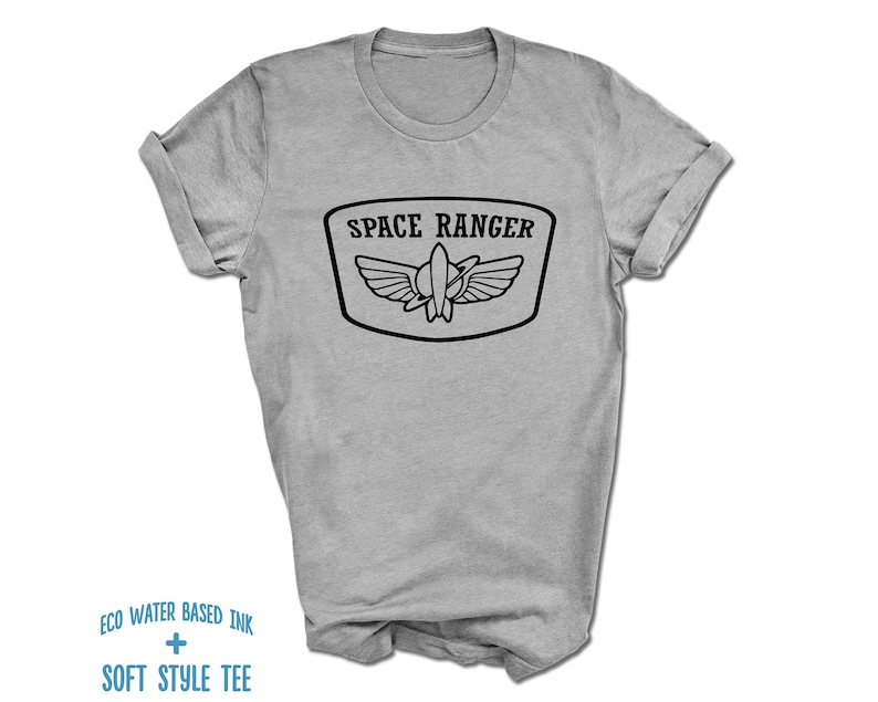 May include: A gray t-shirt with a black graphic of a space ranger patch. The patch has a rocket ship with wings and the text "SPACE RANGER".