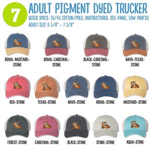 May include: Seven different color variations of a pigment dyed trucker hat with a cartoon tiger embroidered on the front. The hat is made of 55% cotton and 45% polyester. The hat is unstructured, has six panels, and a low profile. The hat is available in adult sizes 6 5/8" to 7 3/8".