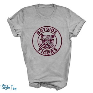 May include: Gray t-shirt with a maroon circle graphic that says "Bayside Tigers" with a tiger face inside the circle.